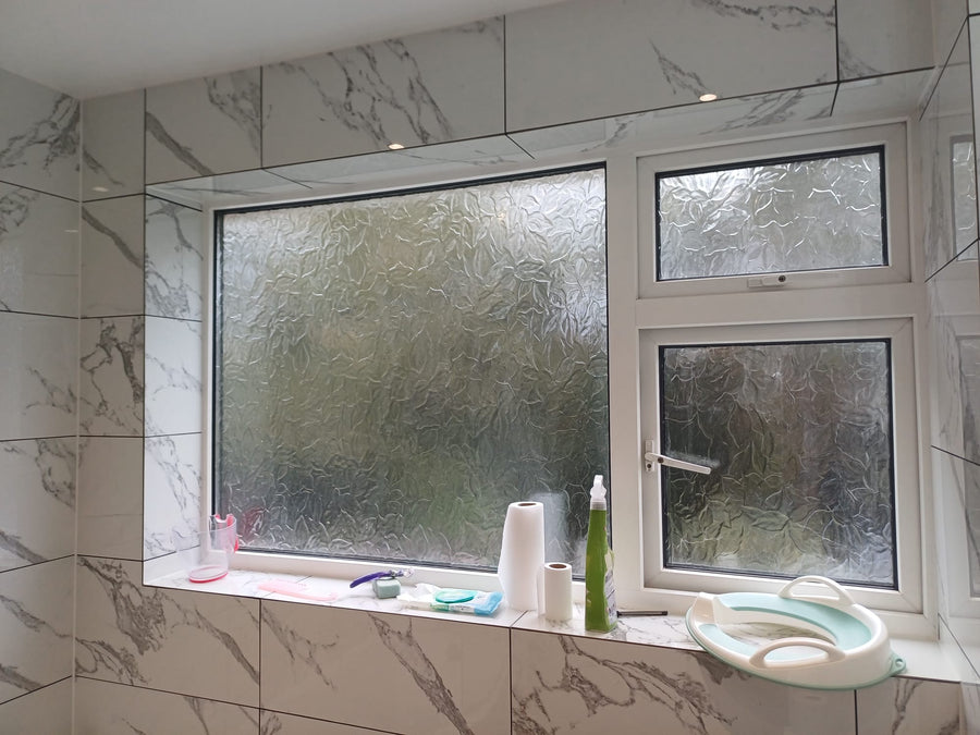Marble-effect tiles around the window