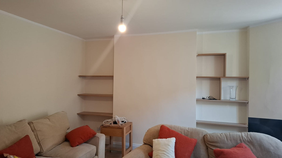 Living room with new shelving built into both alcoves