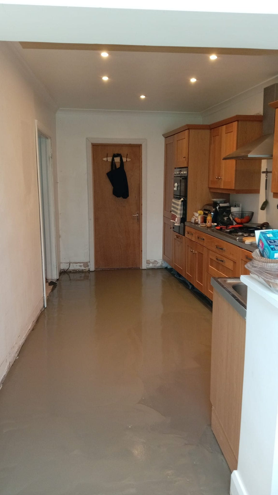 Self-levelling compound poured across the kitchen floor