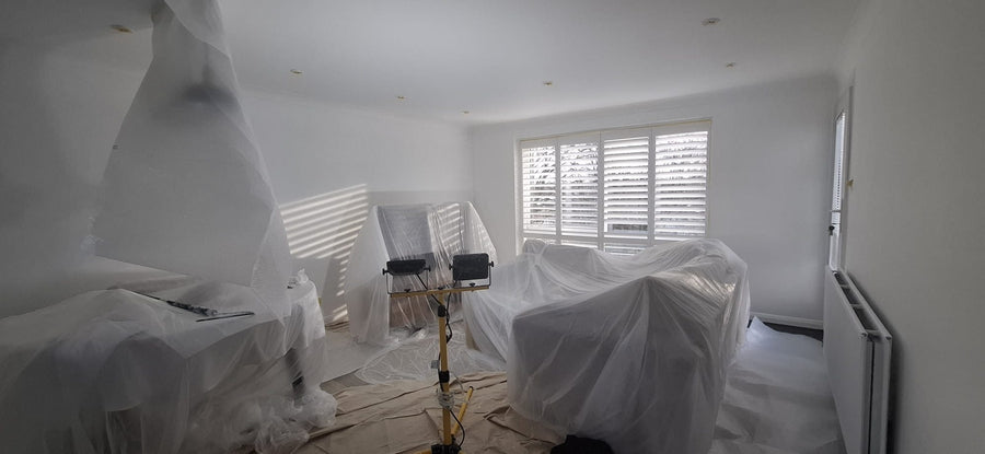 Furniture and floors covered before painting starts
