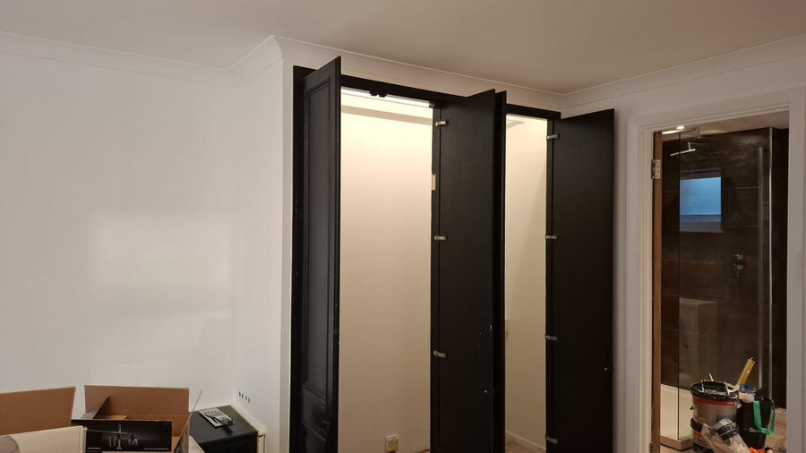 A freshly painted bedroom with fitted wardrobes