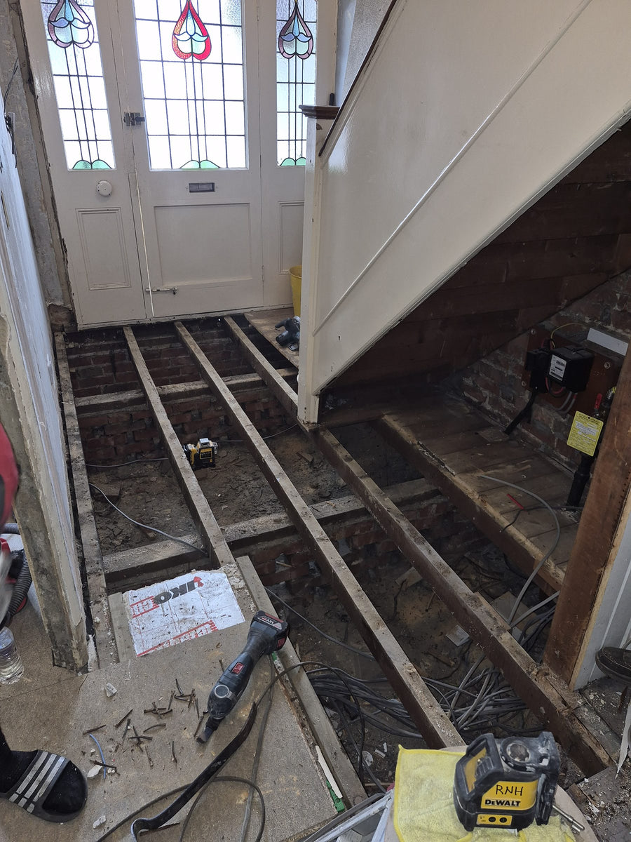 The hallway stripped back to the joists