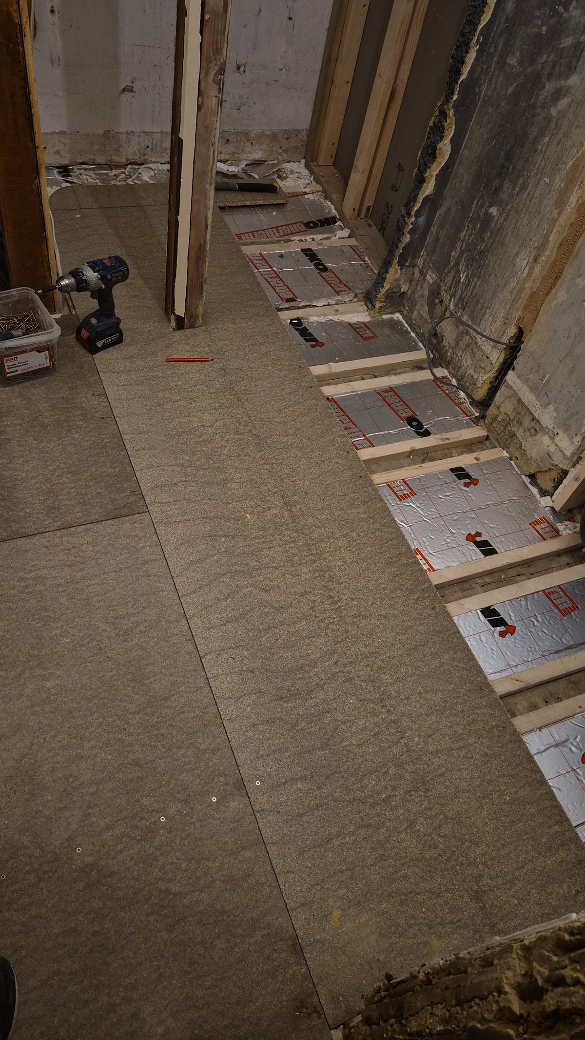 Subfloor boards down in the front room, ready for the final floor