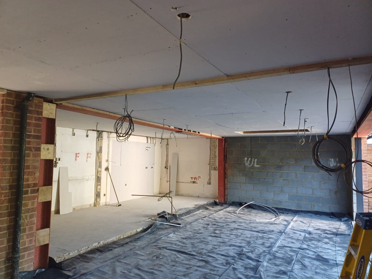 Steel beams and brick piers in the new open-plan space