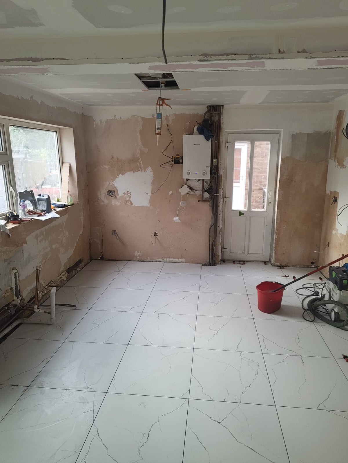 Tiles laid through to the back door, with the ceiling boarded