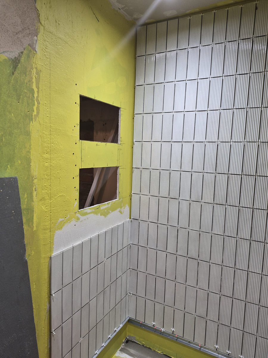 Two recessed niches framed into the shower wall
