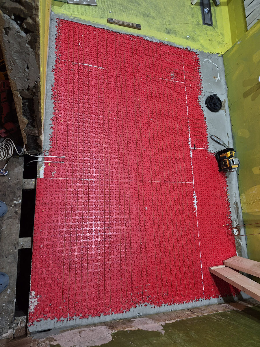 Underfloor heating membrane across the main floor, ready for tiling