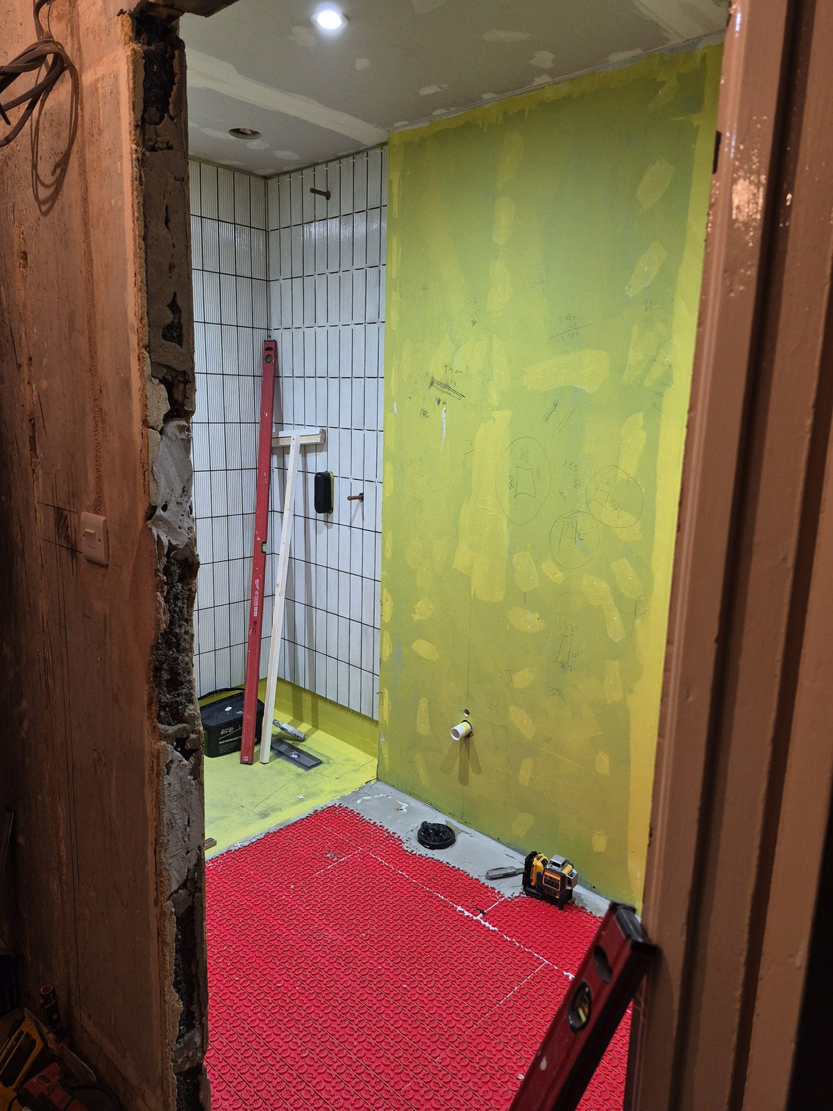 Fluted tiles finished in the shower, with the heating ready for the floor tiles