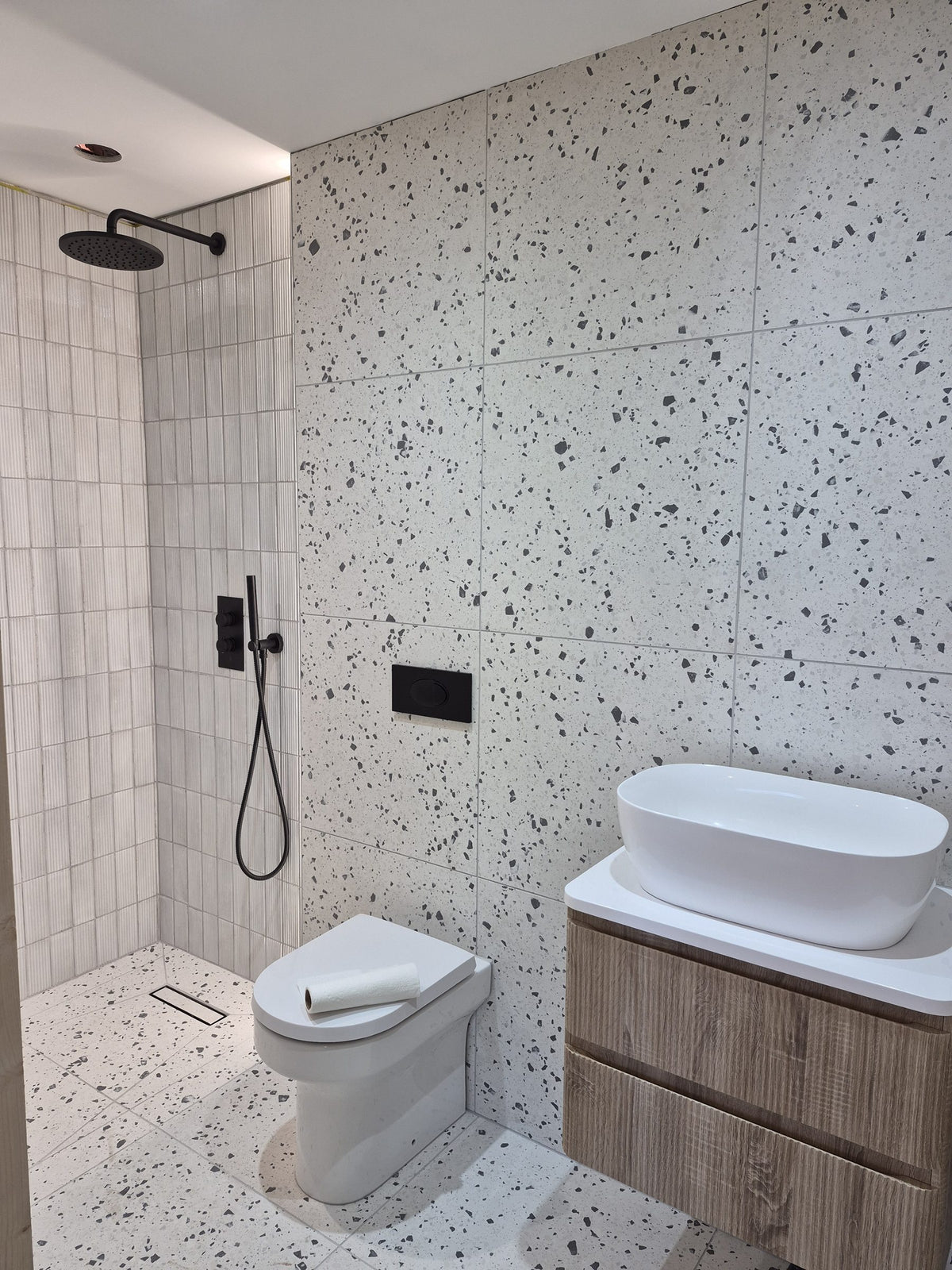 Rainfall shower, back-to-wall toilet and vanity unit in place