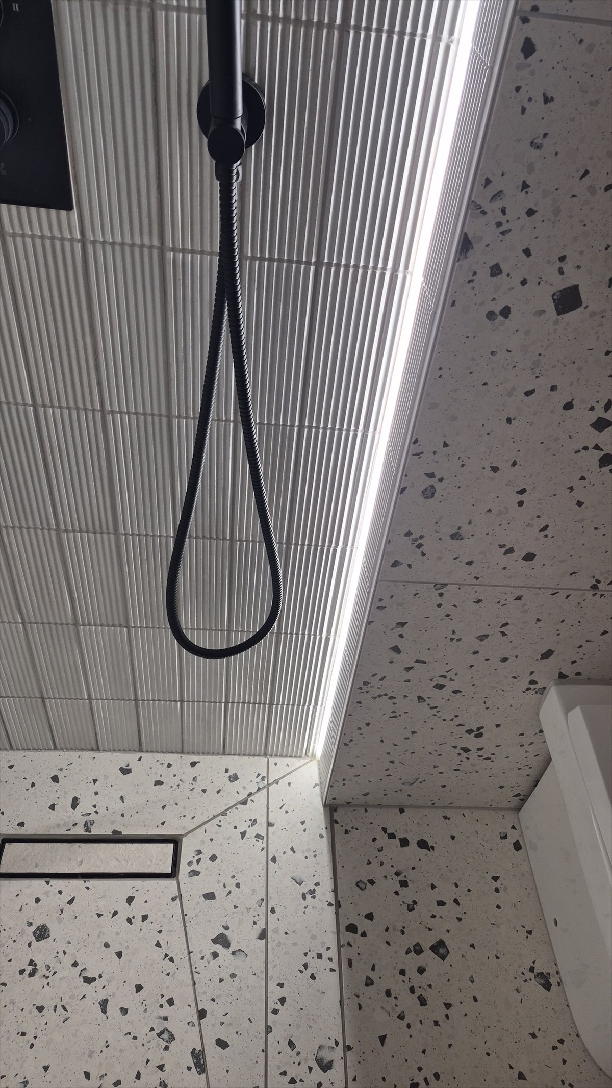 LED strip lighting running down the corner of the walk-in shower