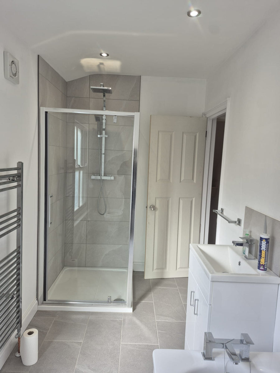 Shower enclosure, vanity unit and heated towel rail