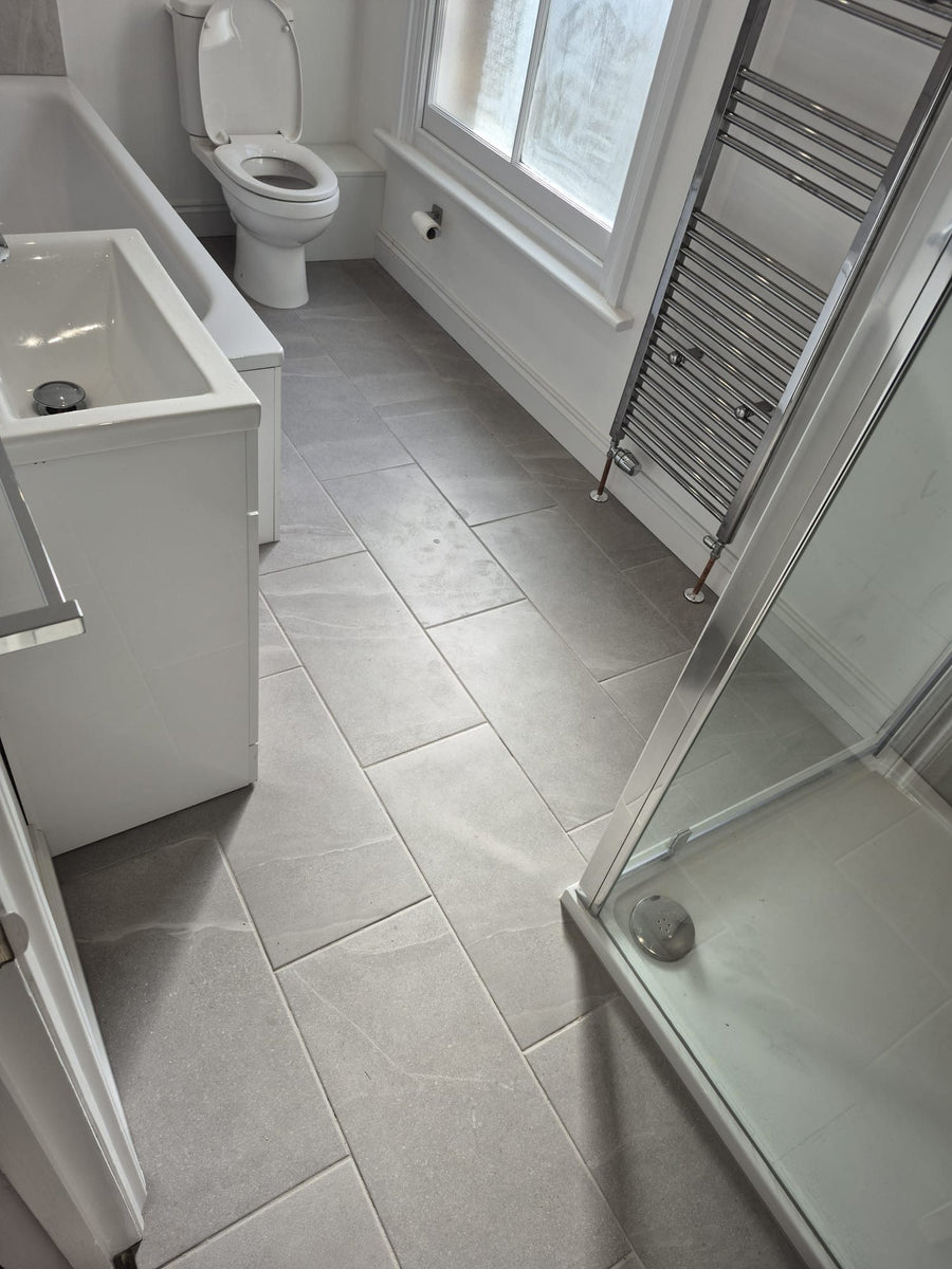 Stone-effect floor tiles laid through the room
