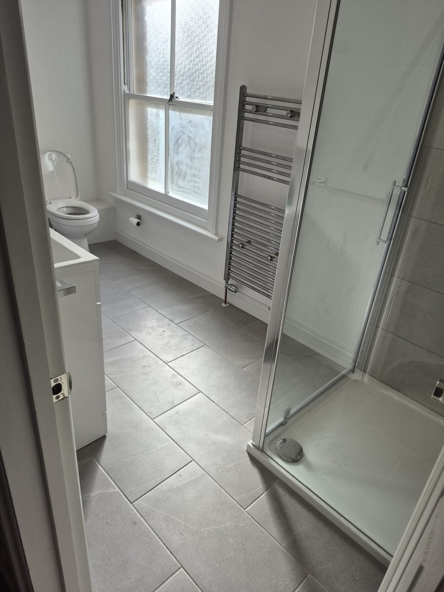 The shower enclosure beside the window