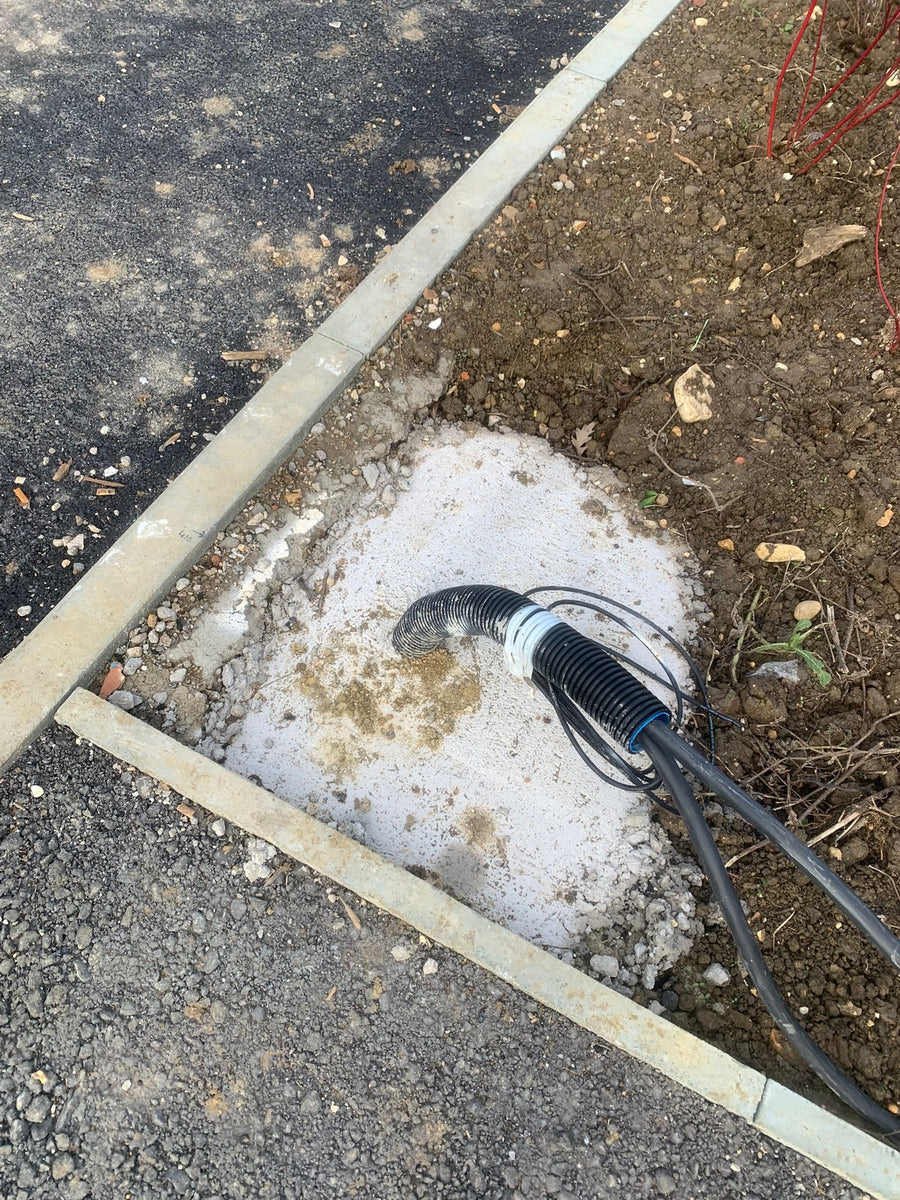A ducted cable run emerging at a post position