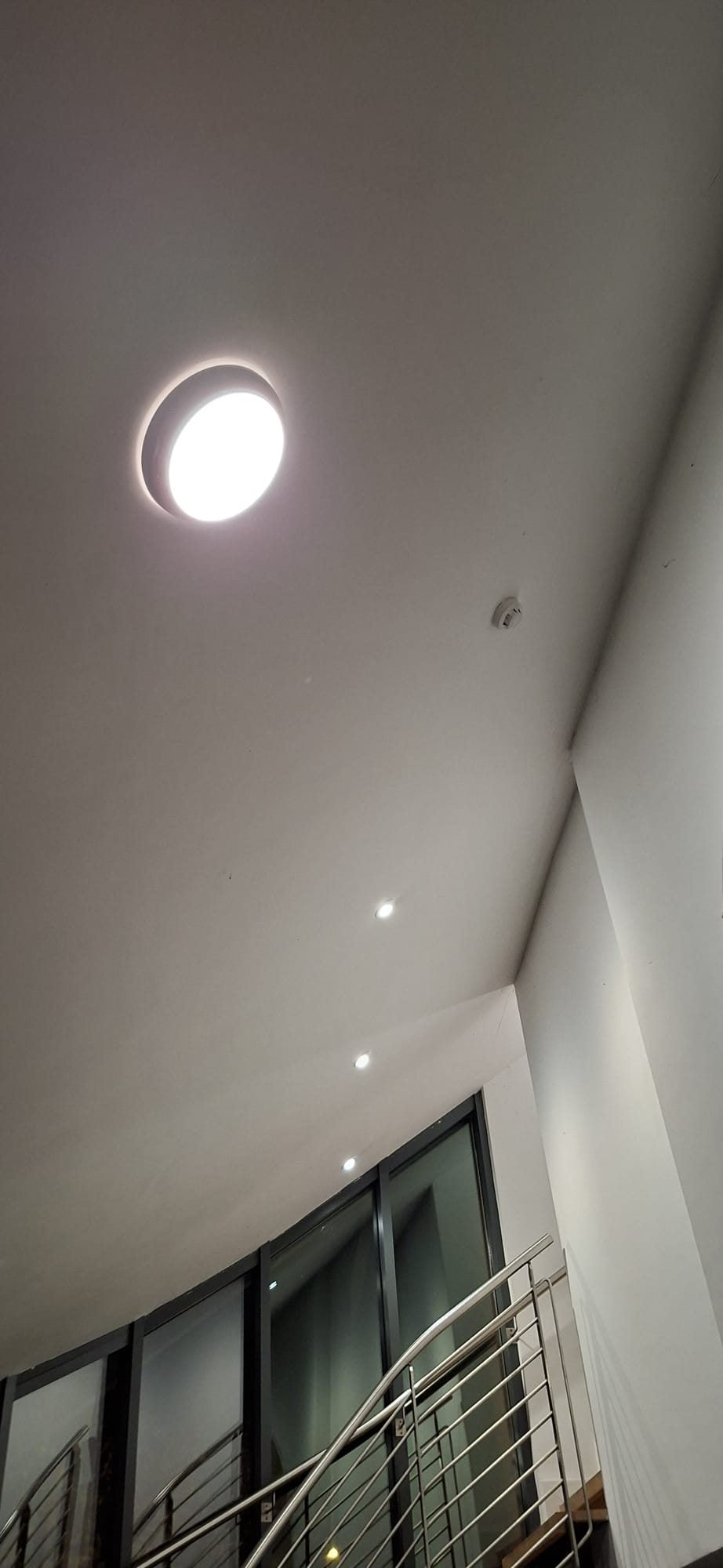 Round LED light above a stairwell