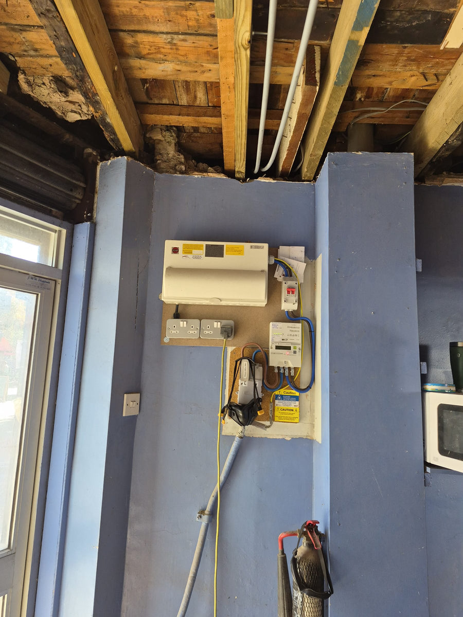An old consumer unit and meter before the upgrade