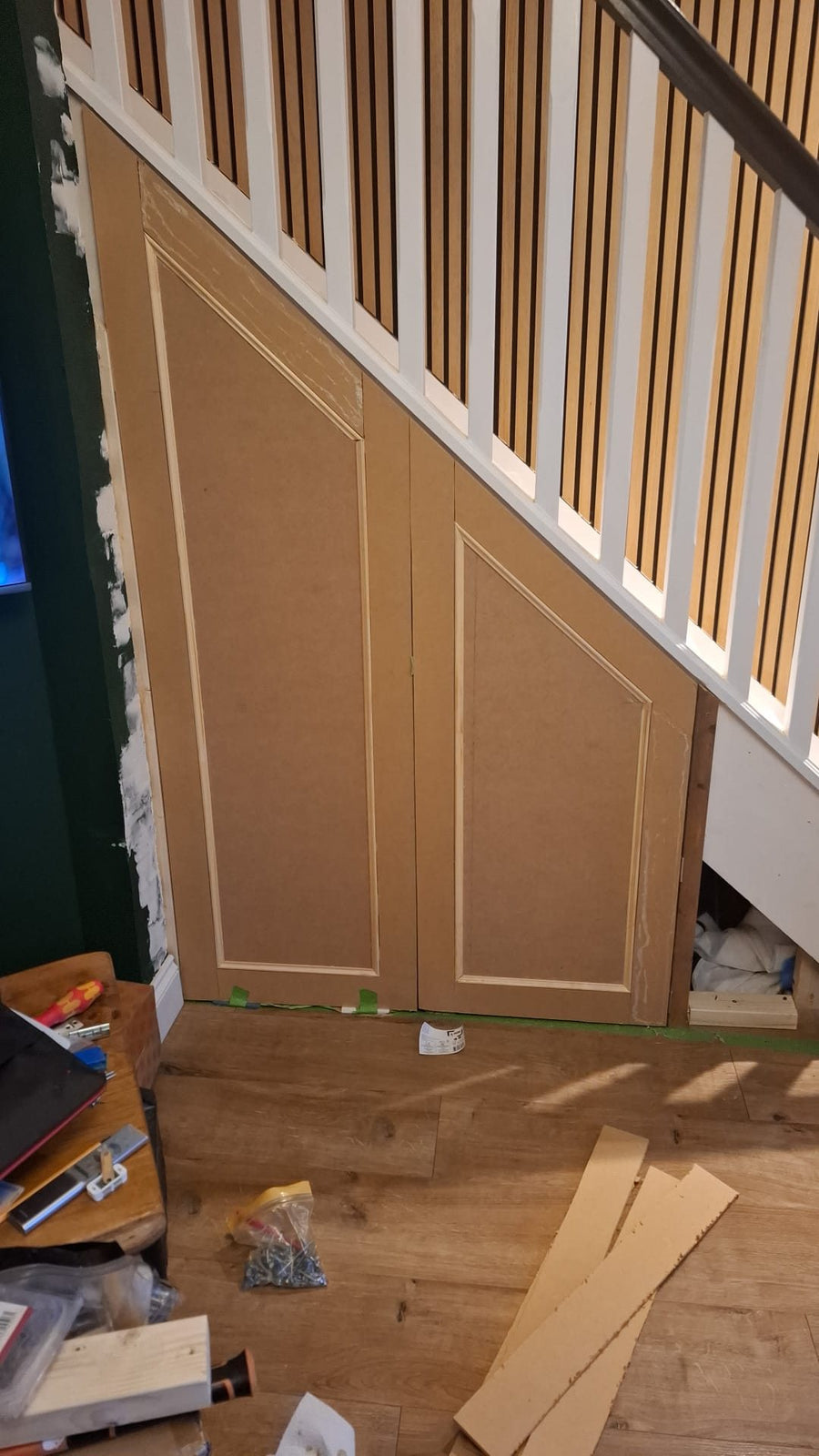Panelled cupboard doors built in under the stairs
