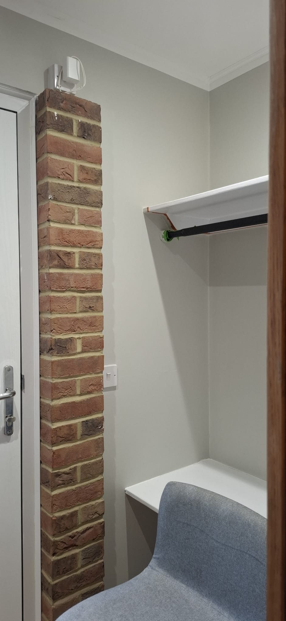 A built-in bench and coat rail inside a porch