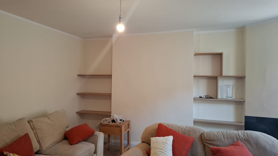 Living room with new shelving built into both alcoves