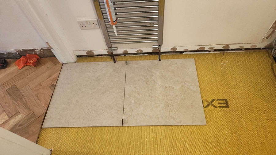 Floor tiles going down in the cloakroom