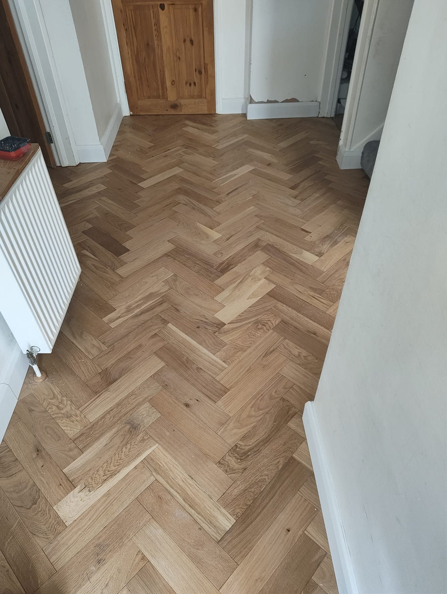 The finished herringbone floor in the hallway
