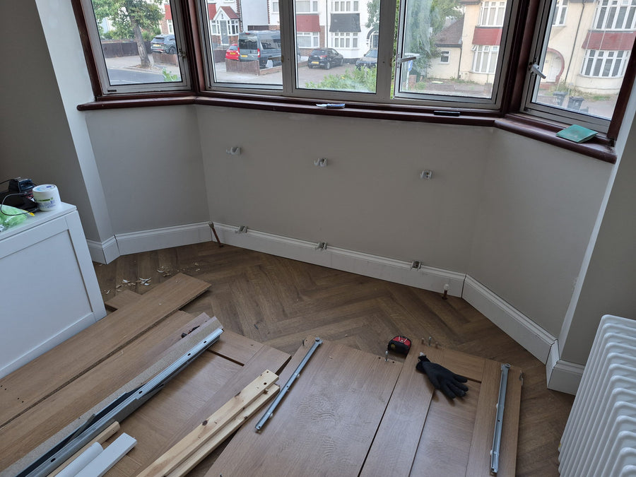 Herringbone flooring and new skirting around a bay window