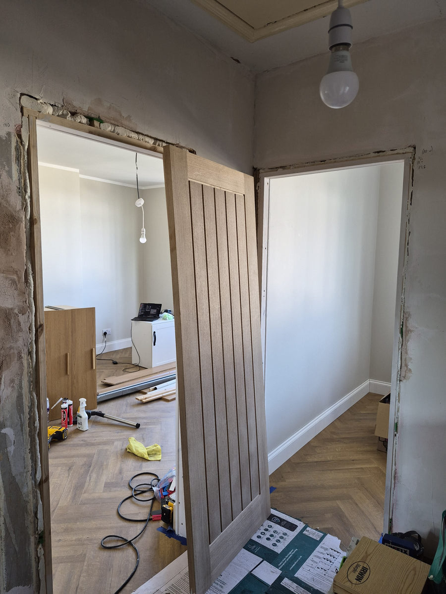 A new oak door ready to hang beside the finished floor