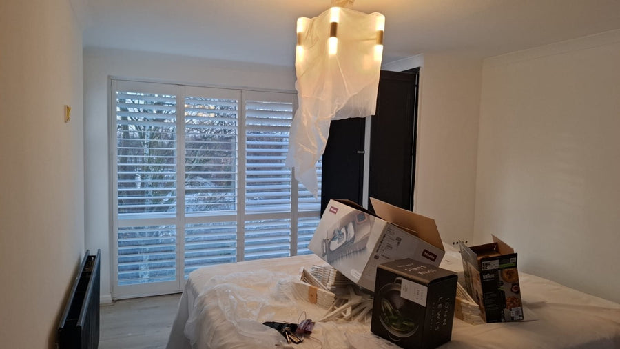 A bedroom finished in fresh white paint