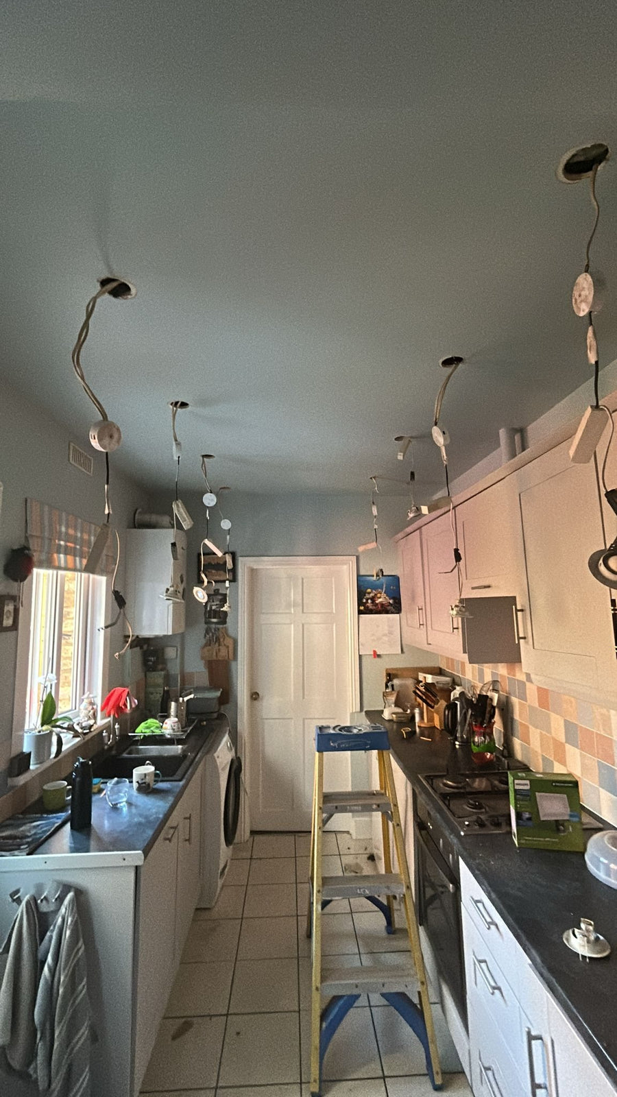 Before: the galley kitchen with its old ceiling lights