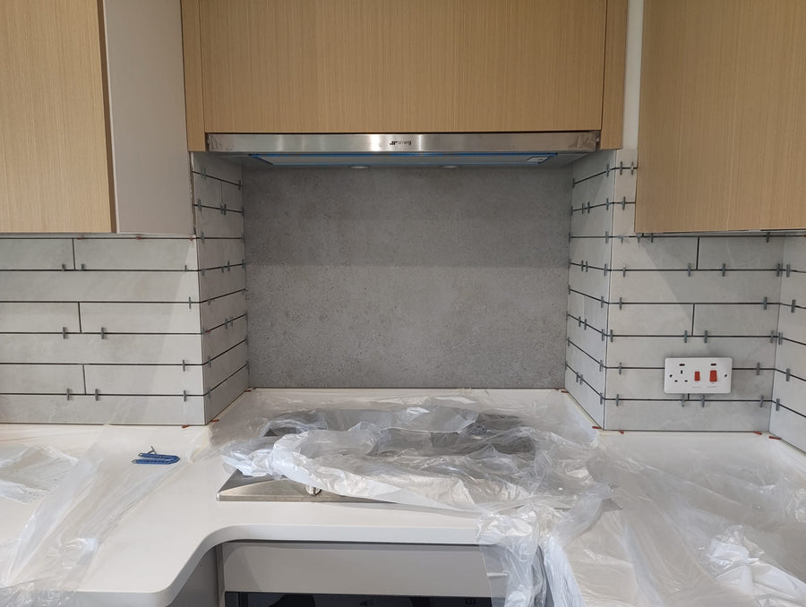 Tiled wall behind the hob, with the worktops protected