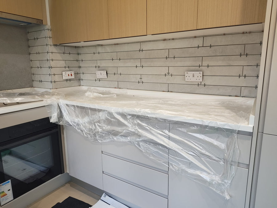 Splashback tiles cut neatly around the sockets