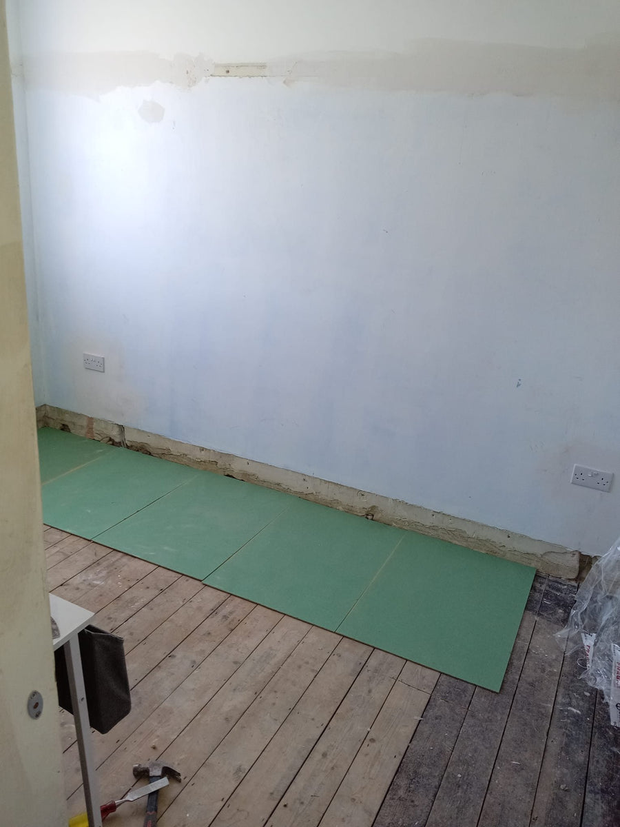Underlay laid across the old floorboards