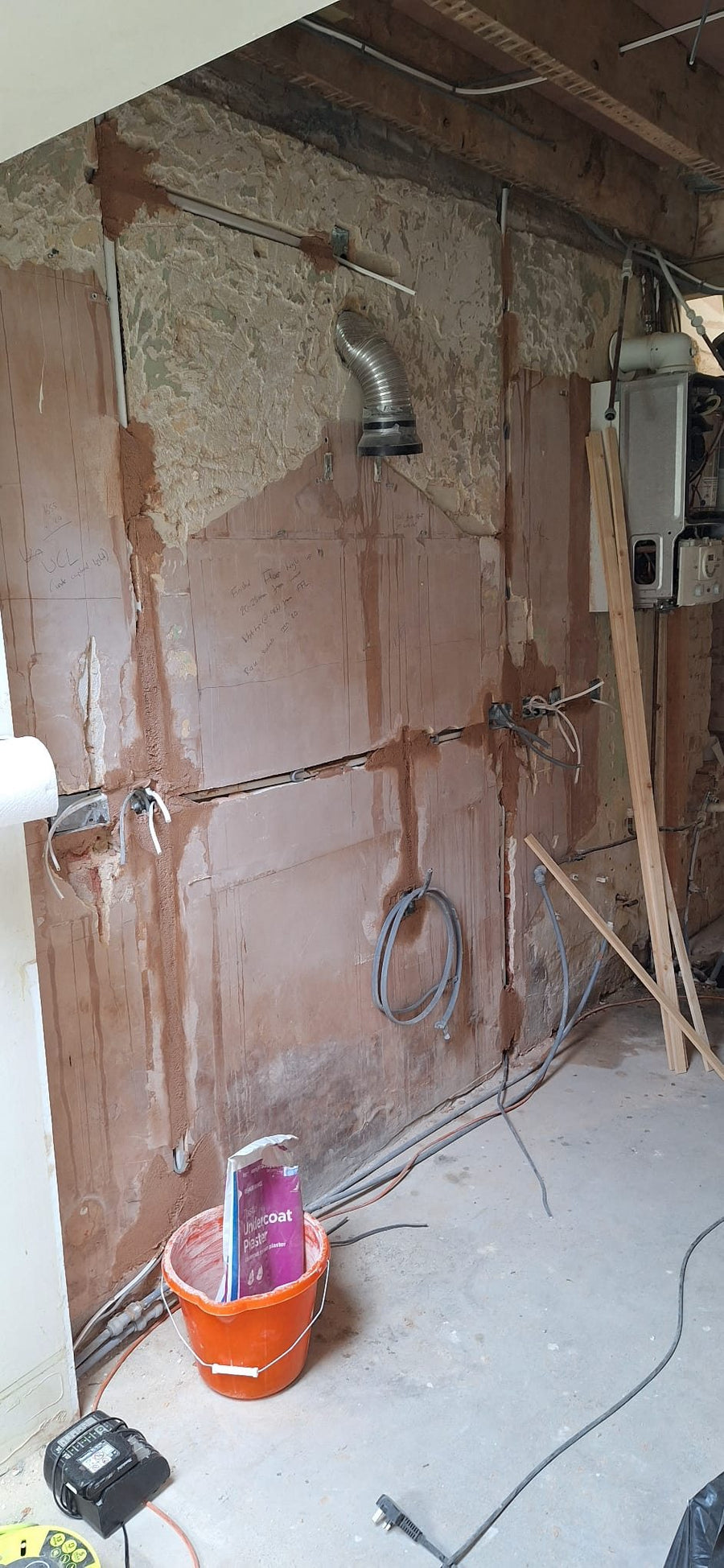 New cables run down a stripped-back wall