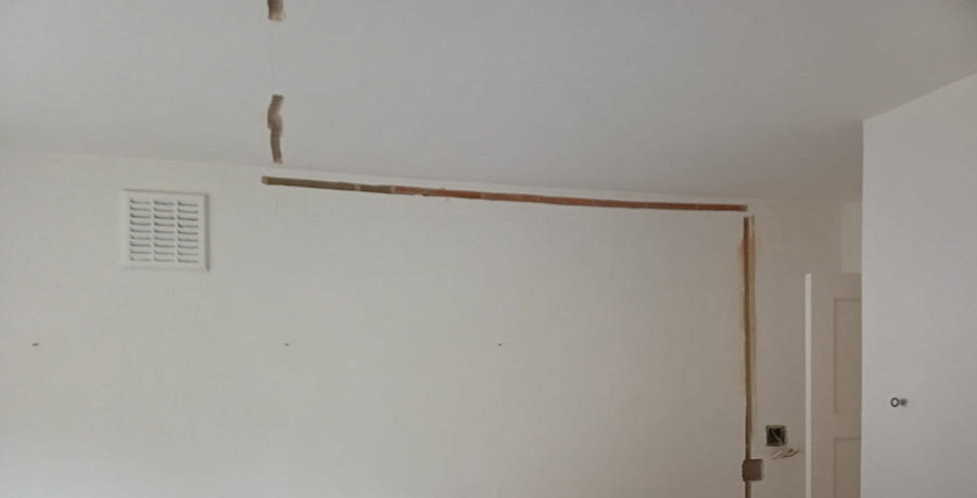 Cable routes chased into the walls of a room