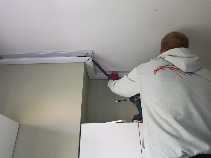 Fitting trunking along the ceiling