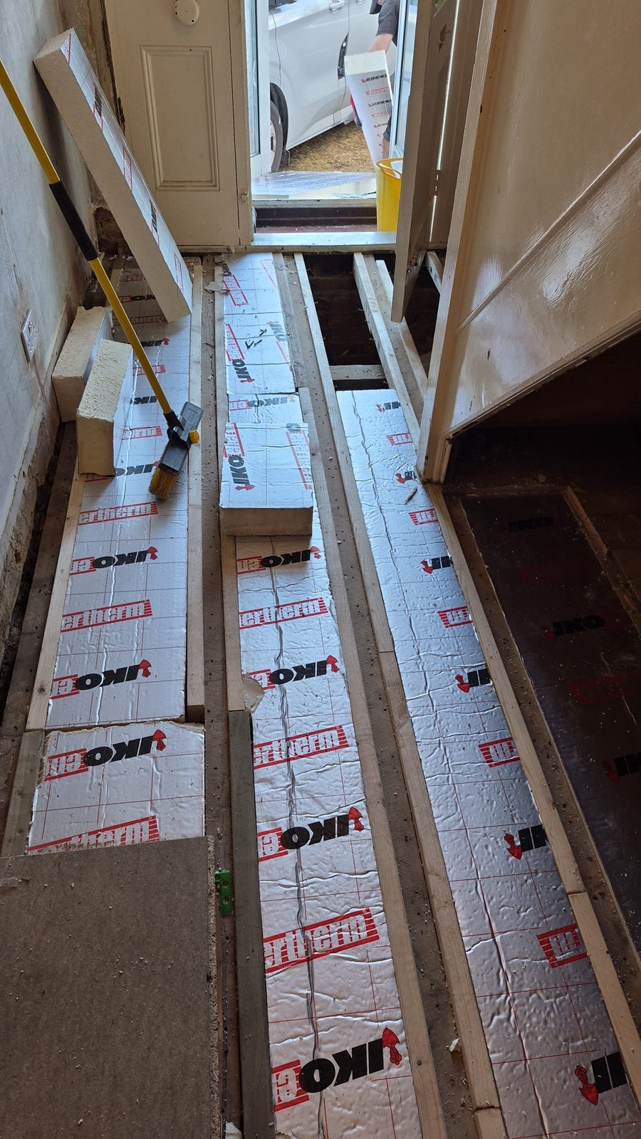 Insulation fitted between the timbers along the hallway