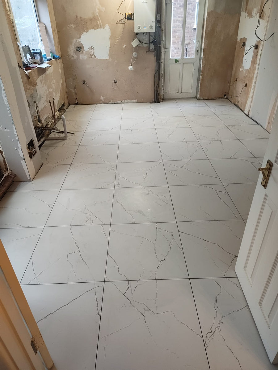 Large marble-effect floor tiles laid across the open-plan space