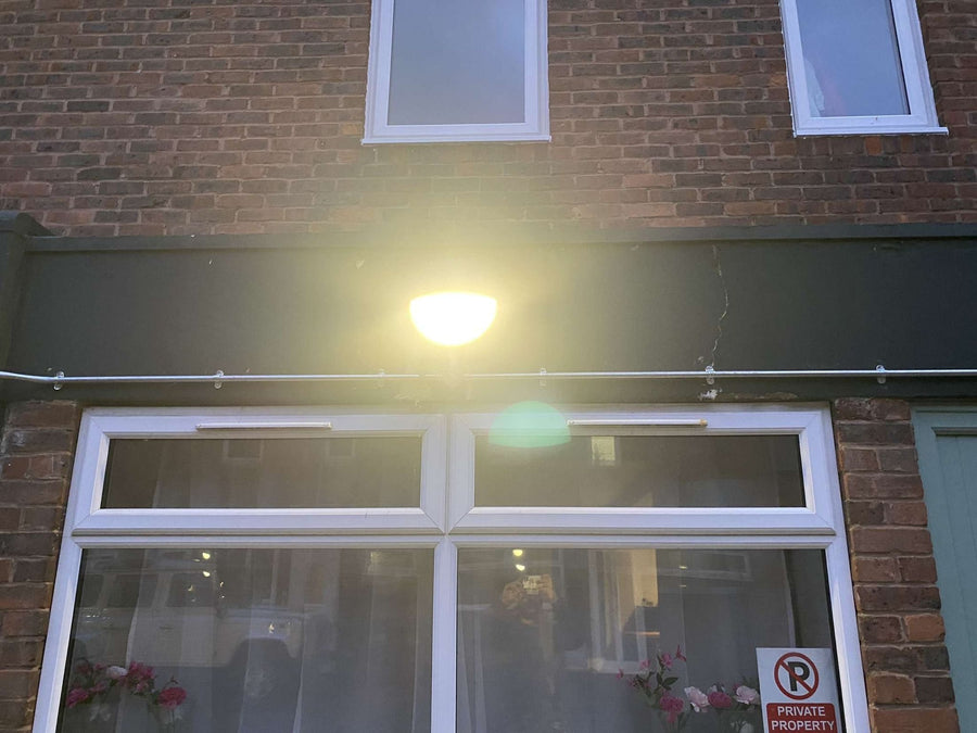 A new light above a ground-floor window after dark