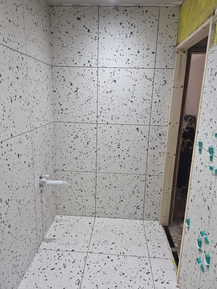 Terrazzo-effect tiles on the walls and floor