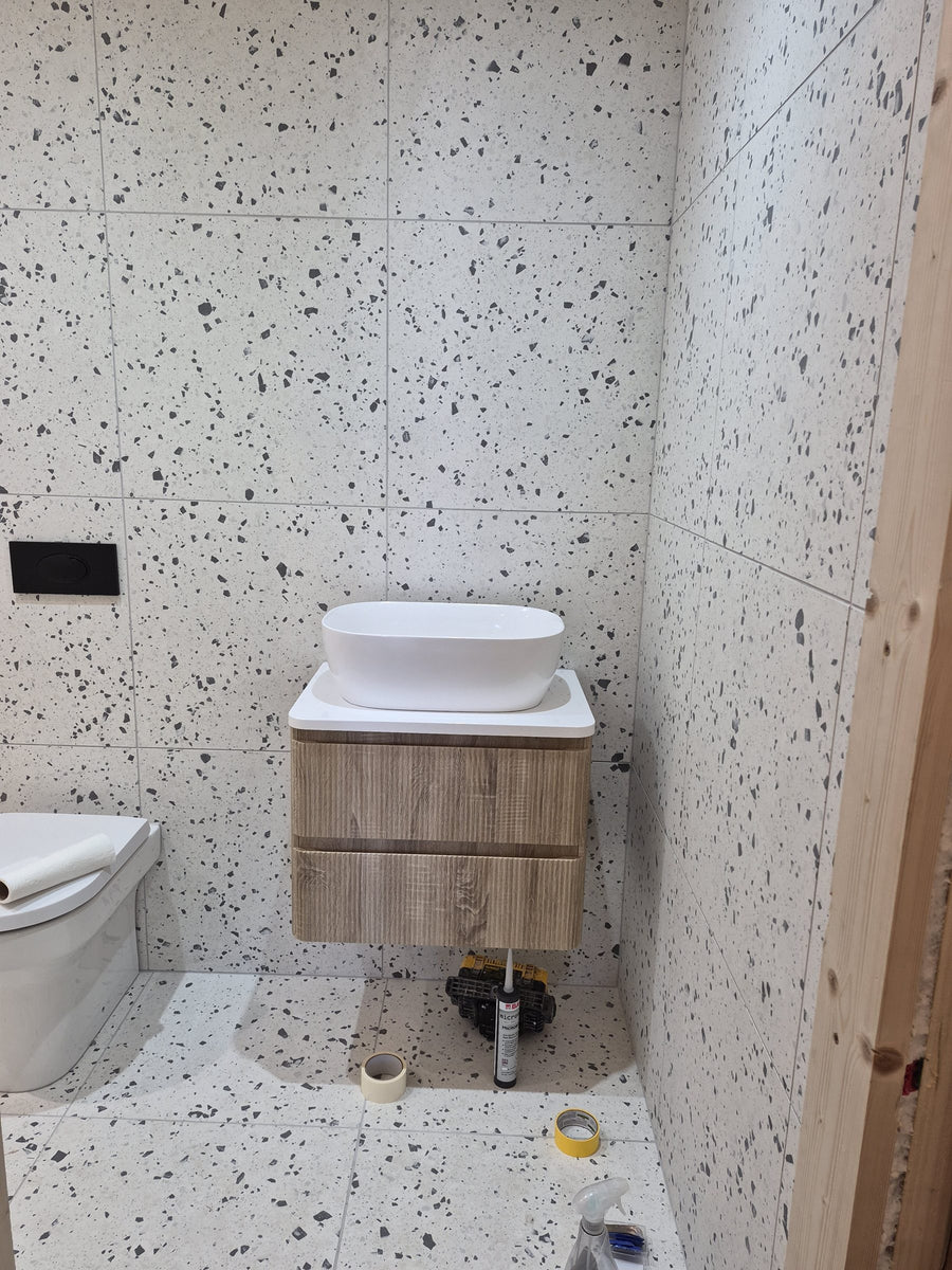 Wall-hung vanity unit and countertop basin being fitted