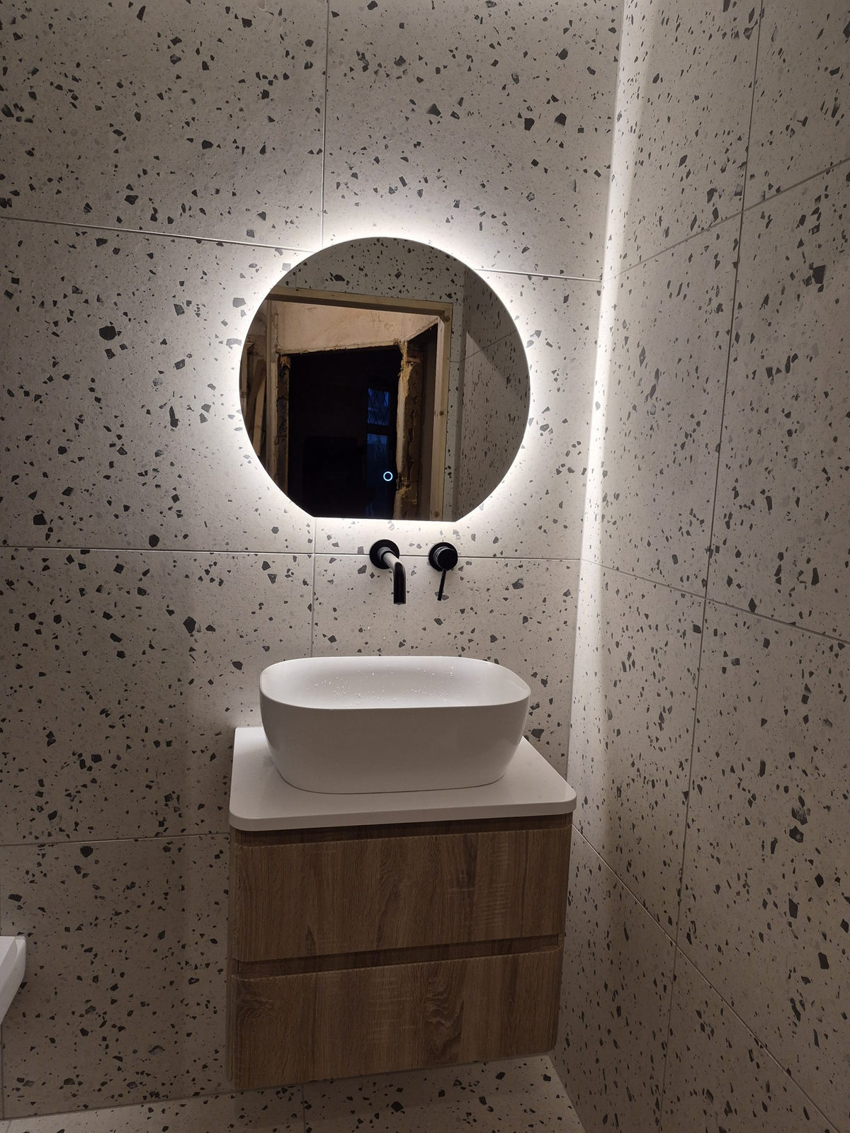 Backlit LED mirror above the wall-hung vanity unit
