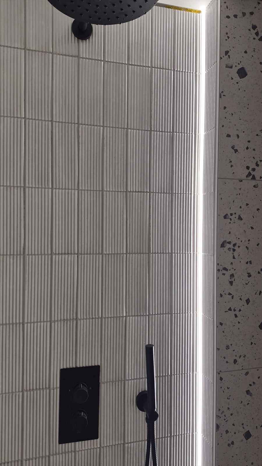 LED strip lighting beside the concealed shower controls
