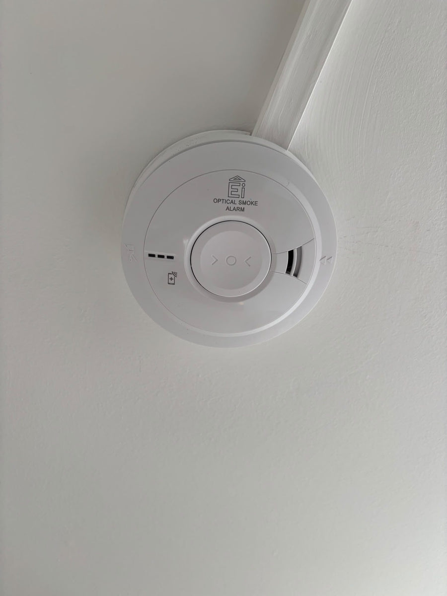 Smoke alarm fed through neat white trunking